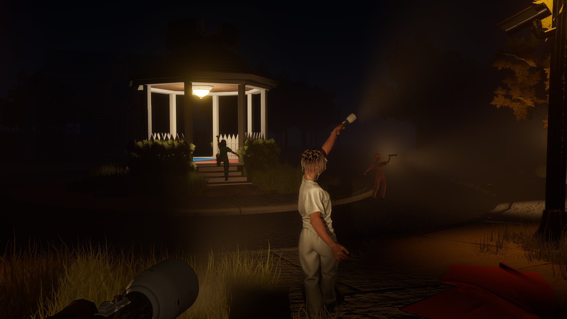 Night. A player points a torch past the lit gazebo.